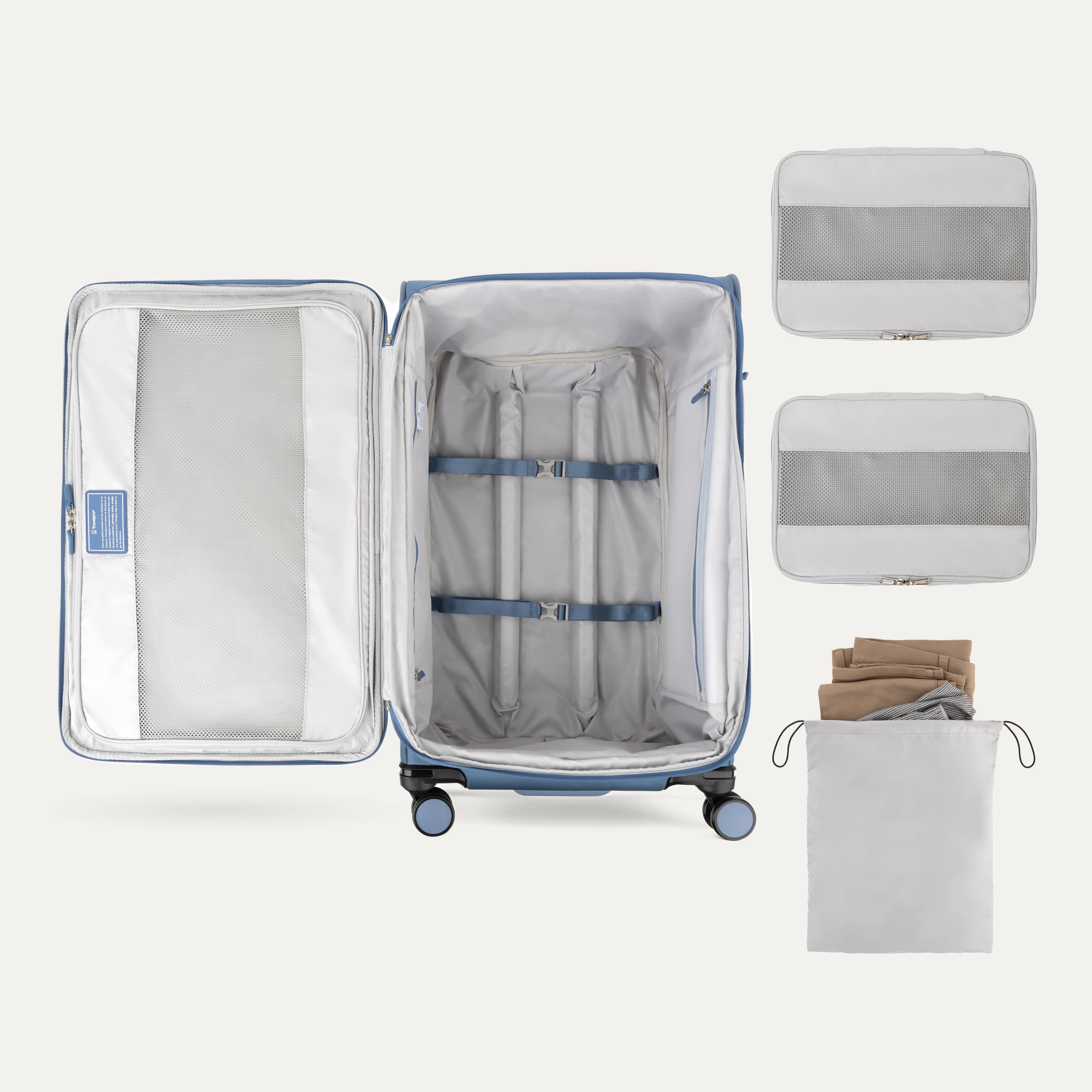 Open suitcase with packing accessories on a white background