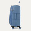 Side view of Travelpro Versapack+ Medium Check-In Spinner in Elemental Blue, showing 360° spinner wheels and PowerScope Lite handle.