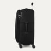 Side view of Travelpro VersaPack+ Large Check-In Spinner in Jet Black, showing 360° Spinner Wheels and PowerScope Extension Handle.