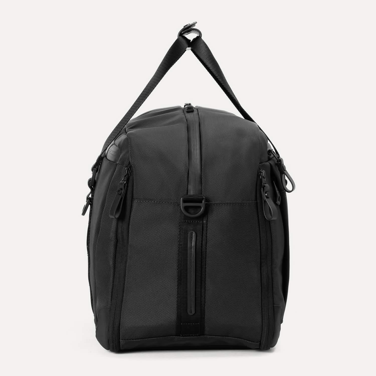 Side view of Travelpro Altitude Double Expansion Duffel in Jet Black with vertical zipper, D-ring, and adjustable strap.