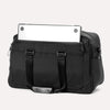 Back view of Travelpro Altitude Double Expansion Duffel in Jet Black with laptop partially tucked in rear zippered pocket.