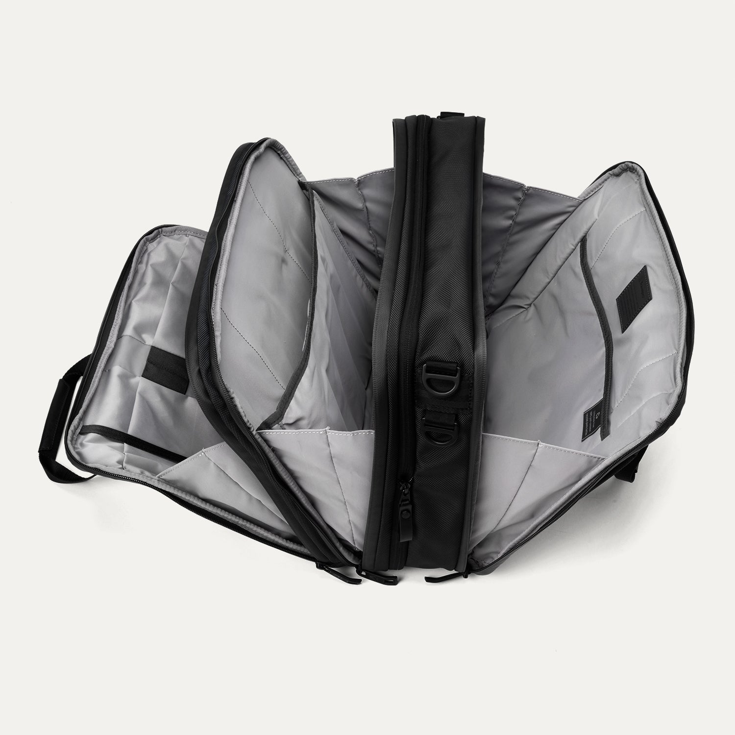 Open view of the Travelpro® Altitude™ Full Expansion Brief in black, showing three spacious compartments with divider panels and organizational sleeves.