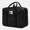 Travelpro® Altitude™ Full Expansion Brief in black, shown with dual top carry handles, vertical webbing accents, and a front slip pocket holding a smartphone.