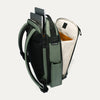 Green backpack with compartments and a laptop sleeve on a white background