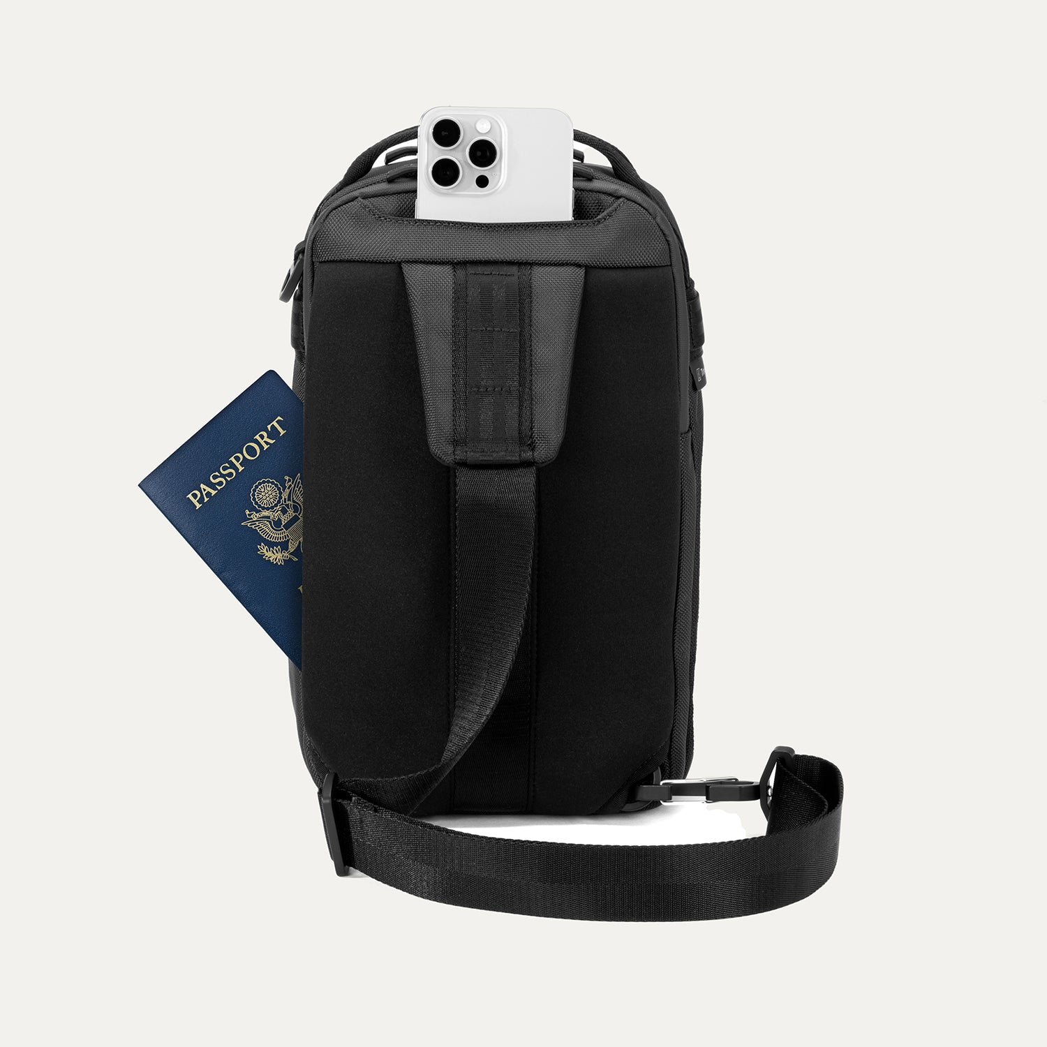 Rear view of Travelpro Altitude Crossbody 6L in Jet Black, showing rear slip pockets with phone and passport access.