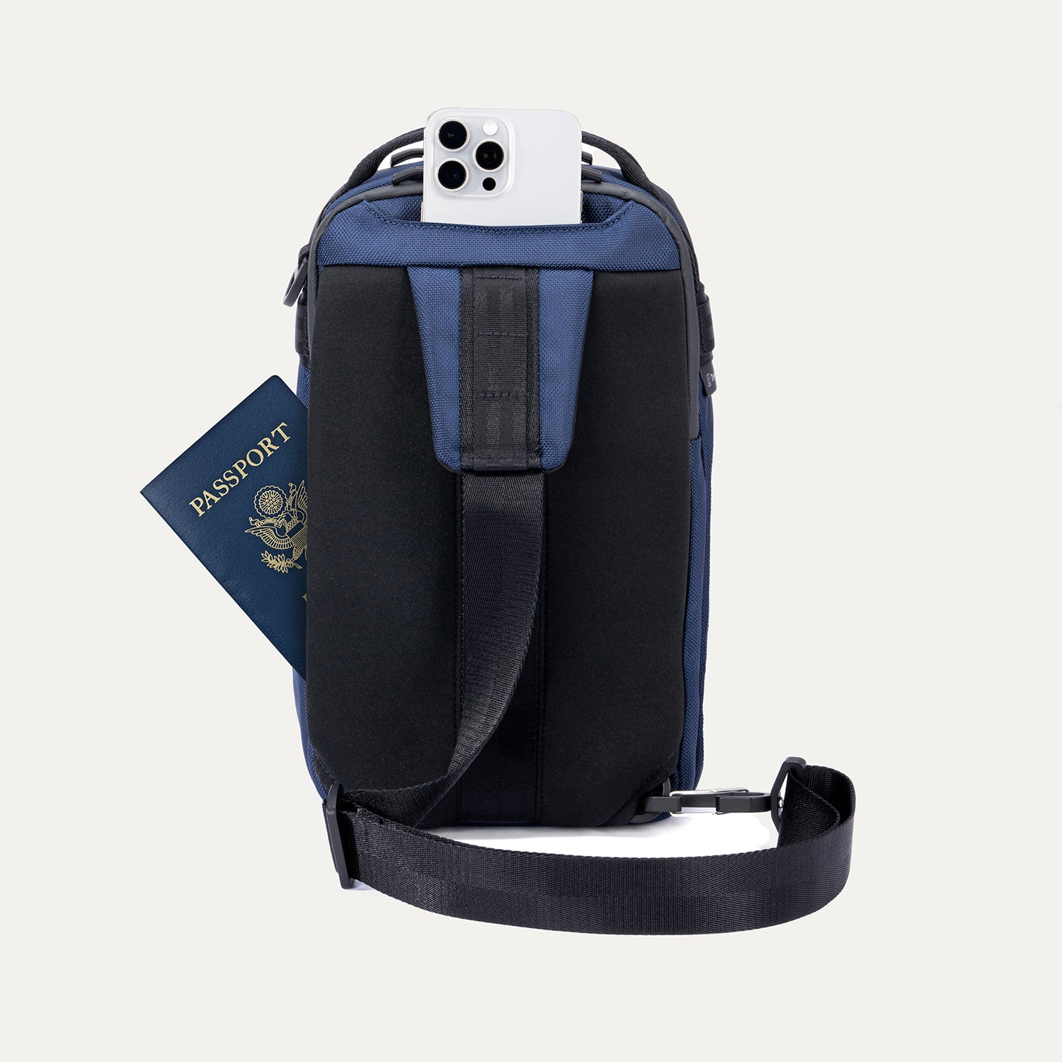 Rear view of Travelpro Altitude Crossbody 6L in Aviator Navy, showing rear slip pockets with phone and passport access.