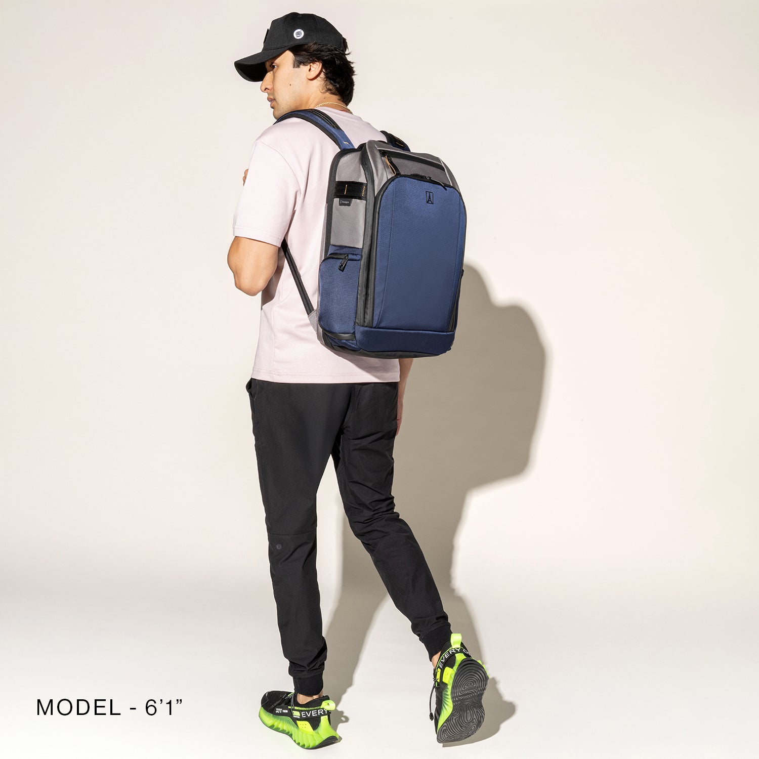 Person wearing a stellar navy backpack on a white background