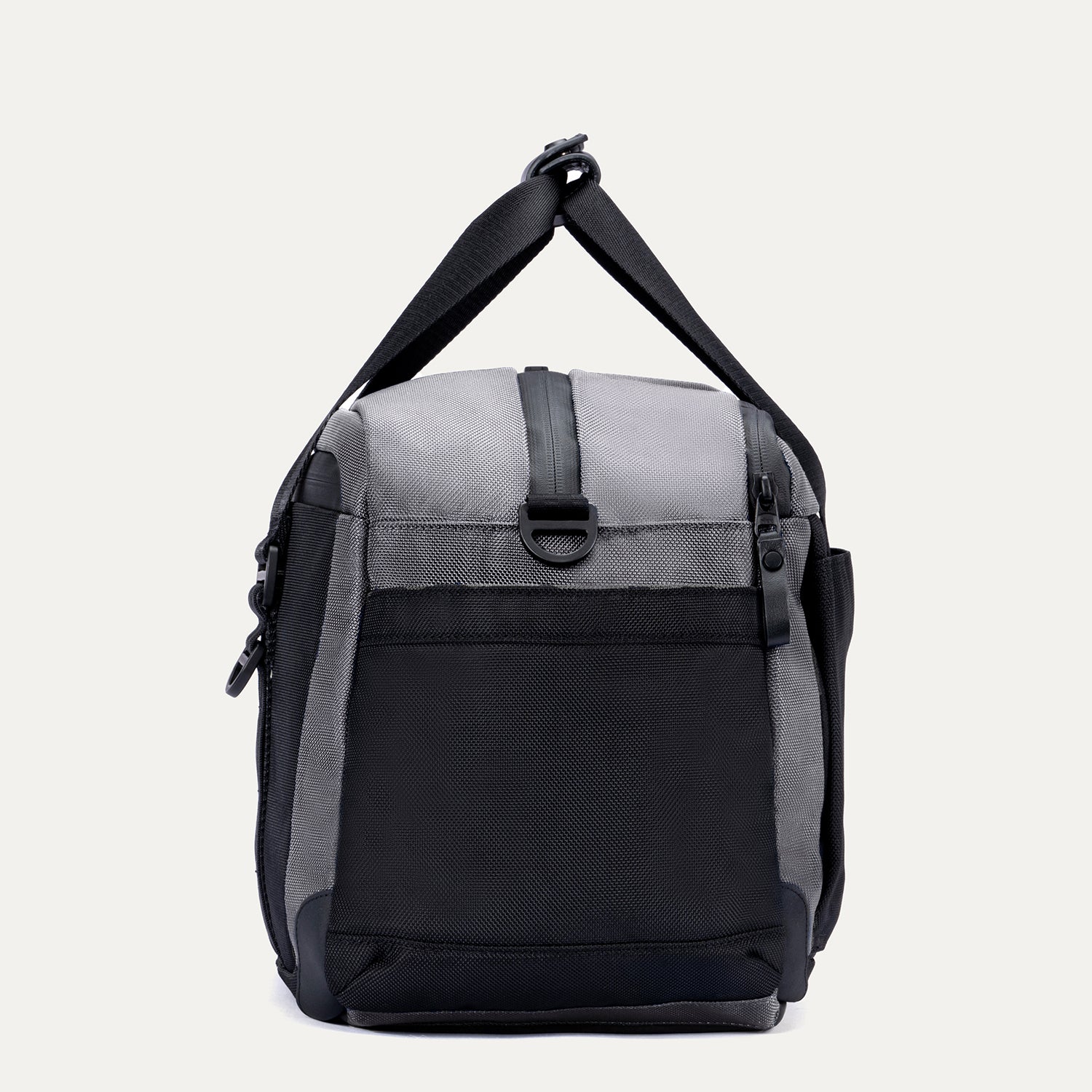 Side view of the Travelpro Altitude Day-to-Day Duffel in Falcon Grey, showing the adjustable shoulder strap and end pocket.