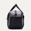 Side view of the Travelpro Altitude Day-to-Day Duffel in Falcon Grey, showing the adjustable shoulder strap and end pocket.