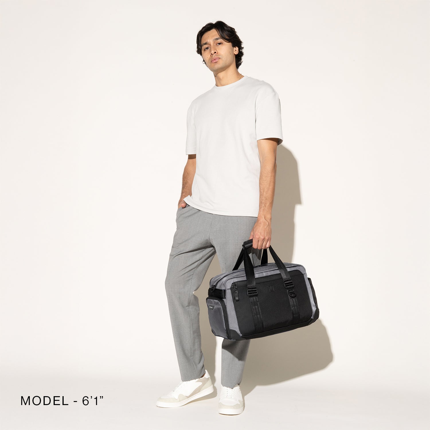 Person carrying a aviator falcon grey on a white background