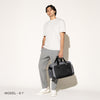 Person carrying a aviator falcon grey on a white background