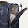Interior view of Travelpro Platinum Elite Spinner in camouflage, showing USB Charging Port and designated power bank pocket.