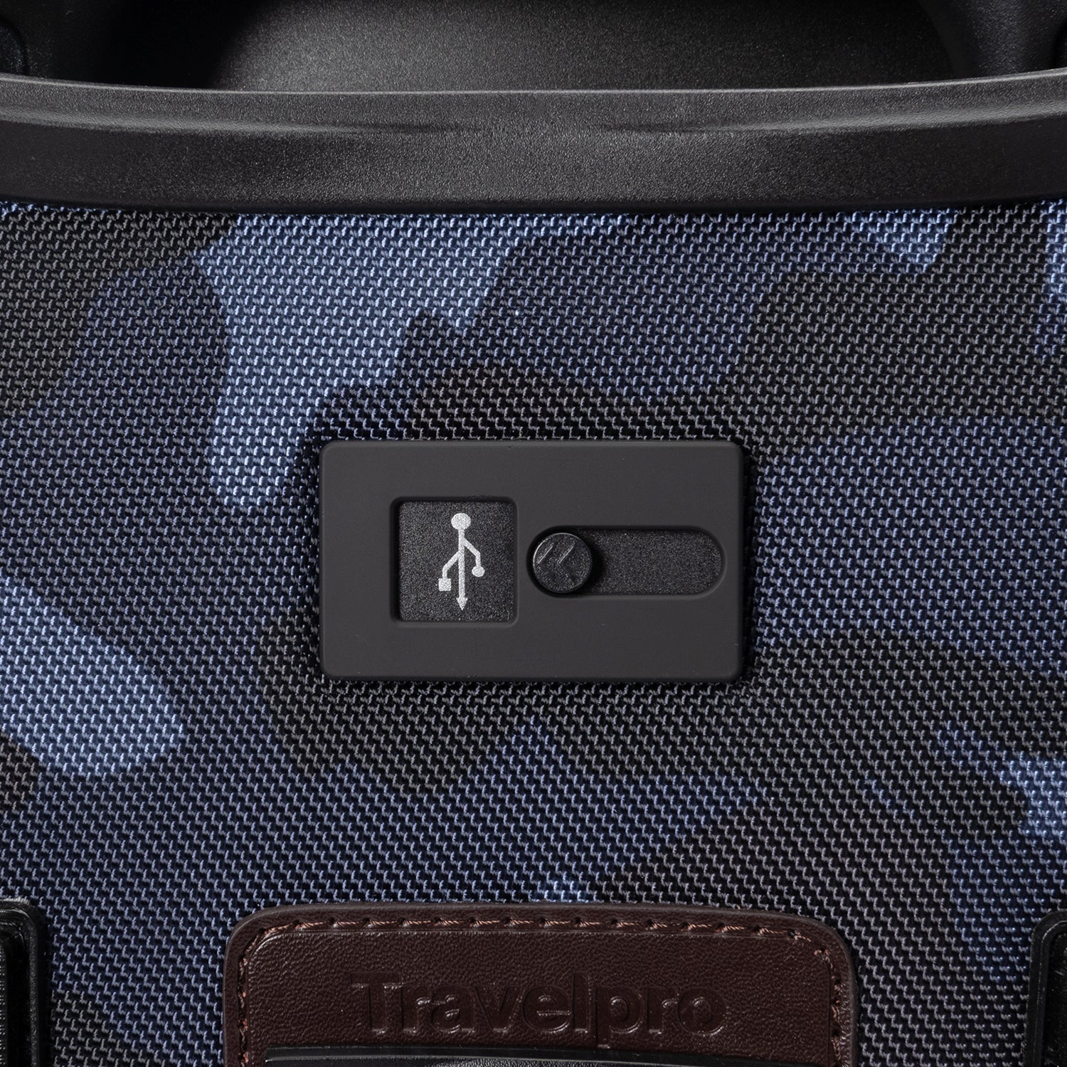 Close-up of the Travelpro Platinum Elite Spinner in Camouflage, featuring external USB Charging Port for on-the-go power.