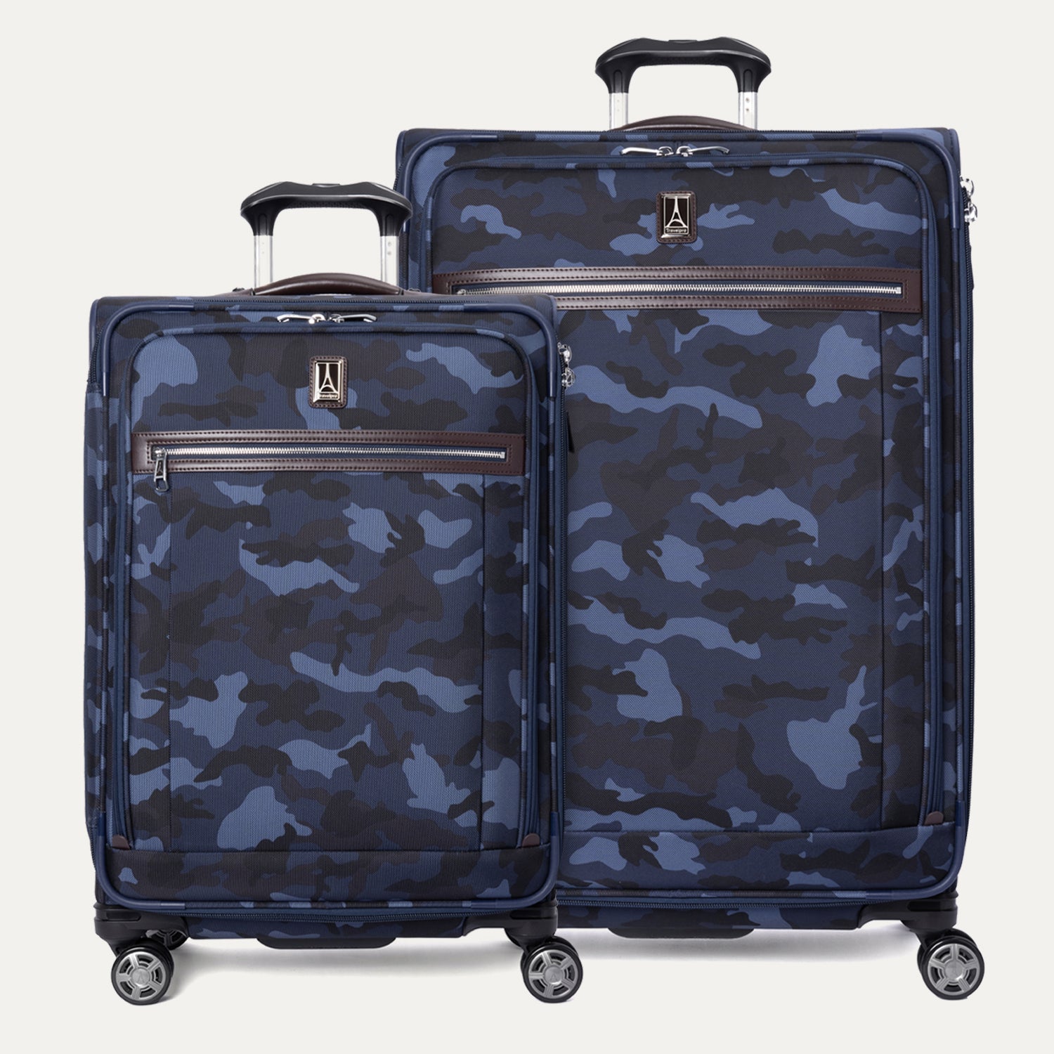 A set of two medium and large sized camouflage patterned spinner suitcases with leather accents and chrome zippers.