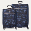 A set of two medium and large sized camouflage patterned spinner suitcases with leather accents and chrome zippers.