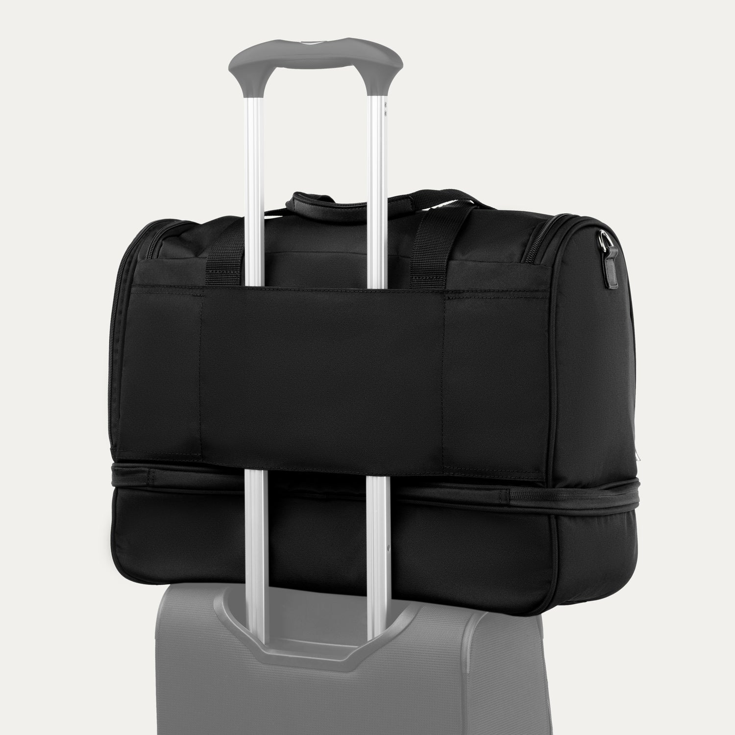 Green weekender bag with rear strap on a white background