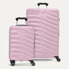 two pink hardside suitcases on a white background