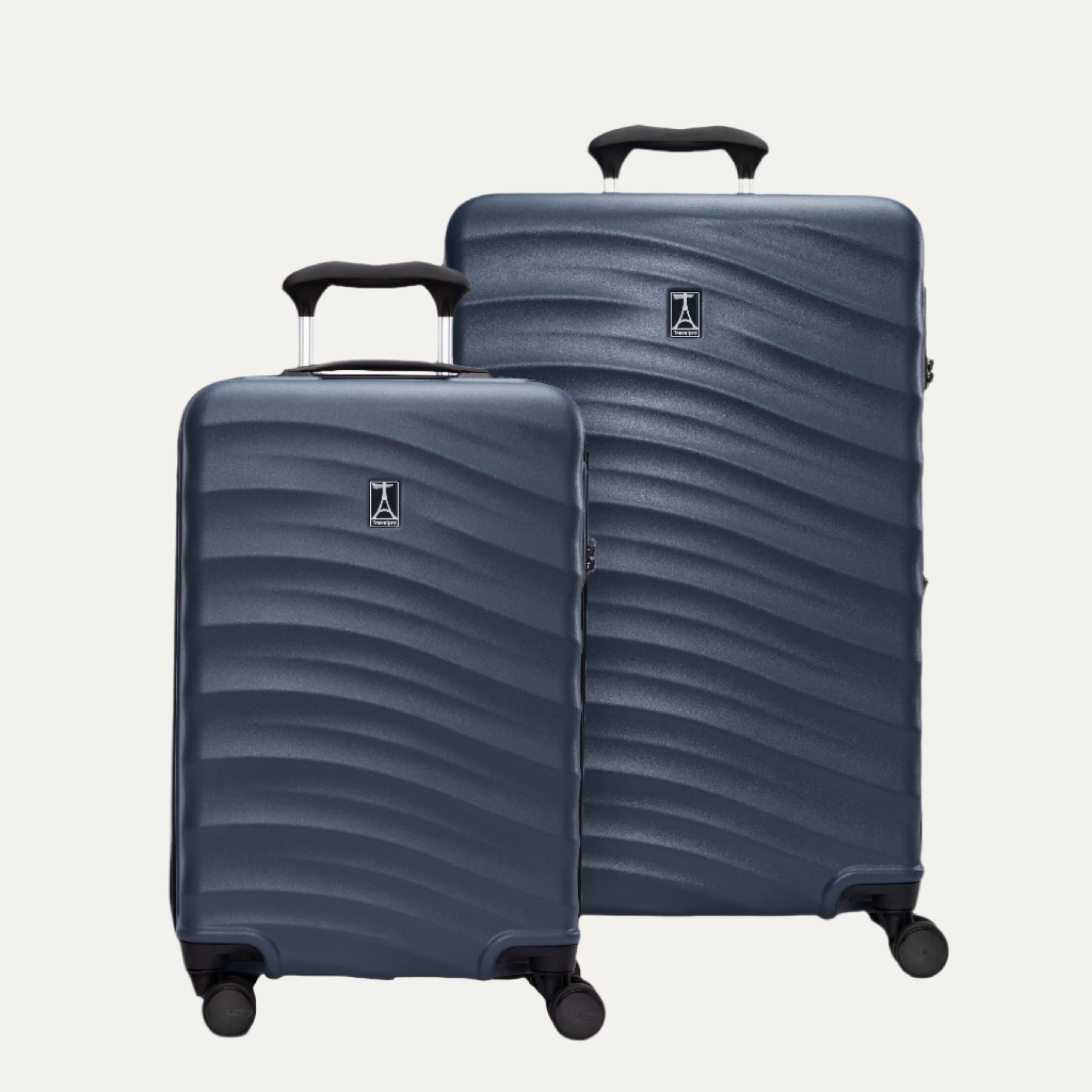 A set of two blue hardside spinner suitcases, one carry-on size and one medium check-in size, with a textured surface, integrated handles, and wheels.