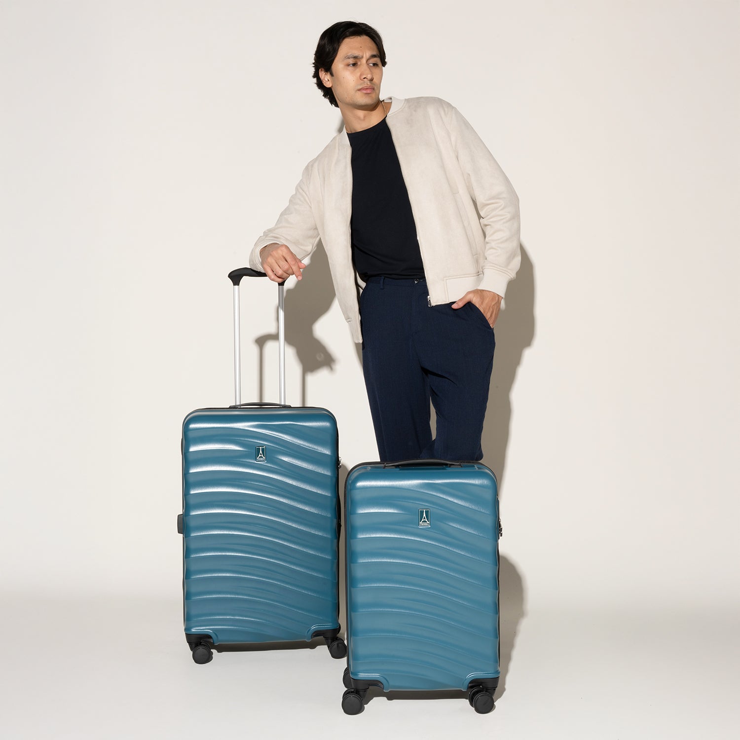 Man standing alongside the Travelpro Maxlite Air V2 Carry-On and Medium Check-In Set in Teal, featuring textured shell and 360° Spinner Wheels.