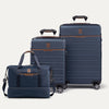 Two blue suitcases and a weekender with brown accents on a white background