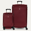 A set of two red spinner suitcases, one carry-on and one large check-in size, with the travelpro logo visible on them.