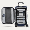 Open navy suitcase with organized contents on a white background