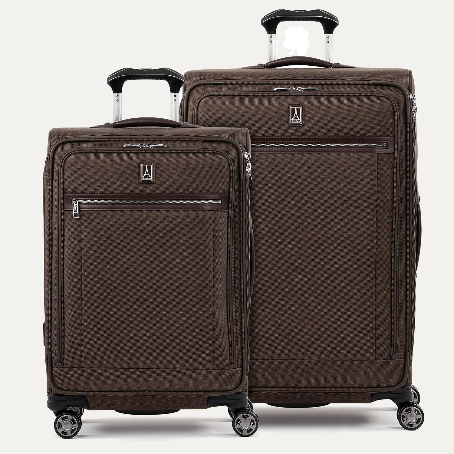 A set of two brown suitcases with spinner wheels, a smaller one in front and a larger one behind, both with the Travelpro logo.