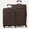 A set of two brown suitcases with spinner wheels, a smaller one in front and a larger one behind, both with the Travelpro logo.