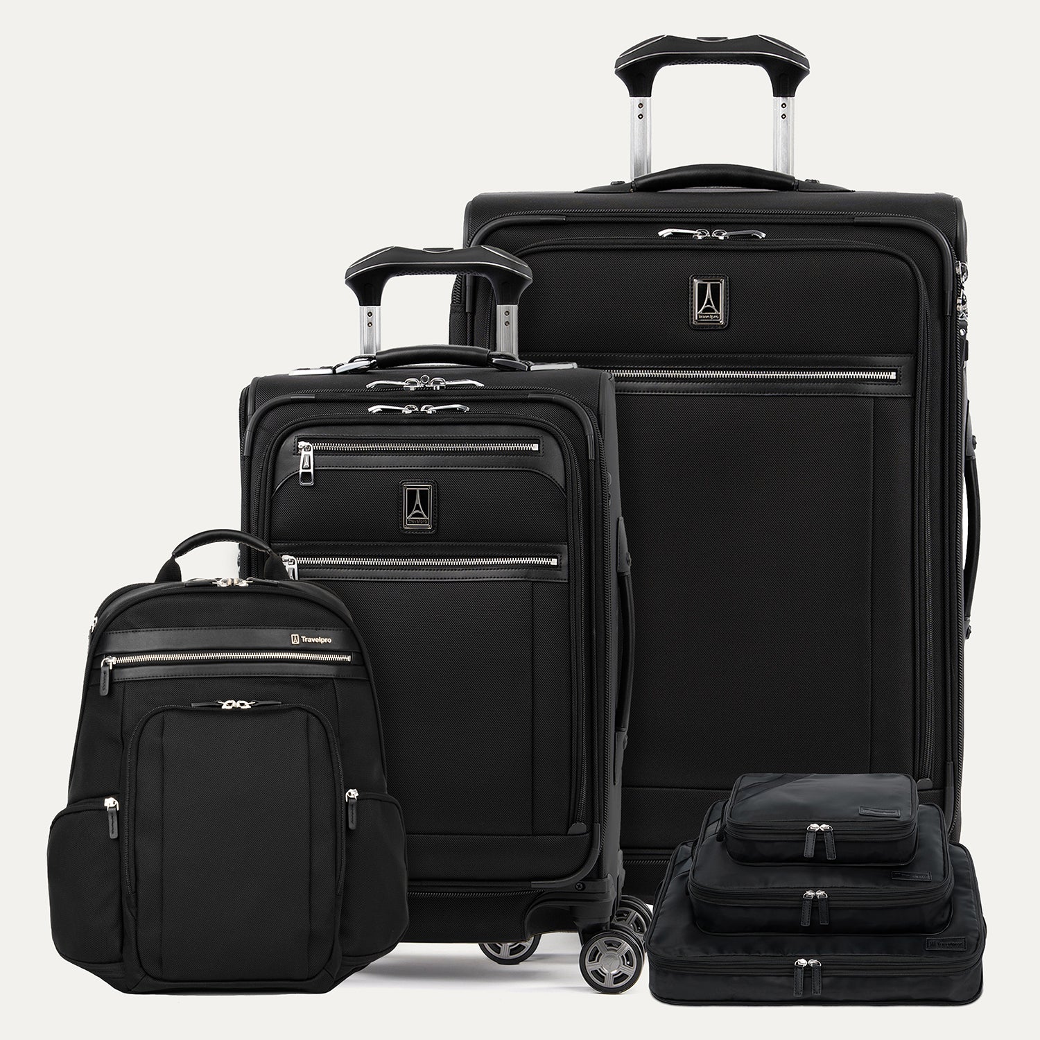 Set of black suitcases and backpack on a light gray background
