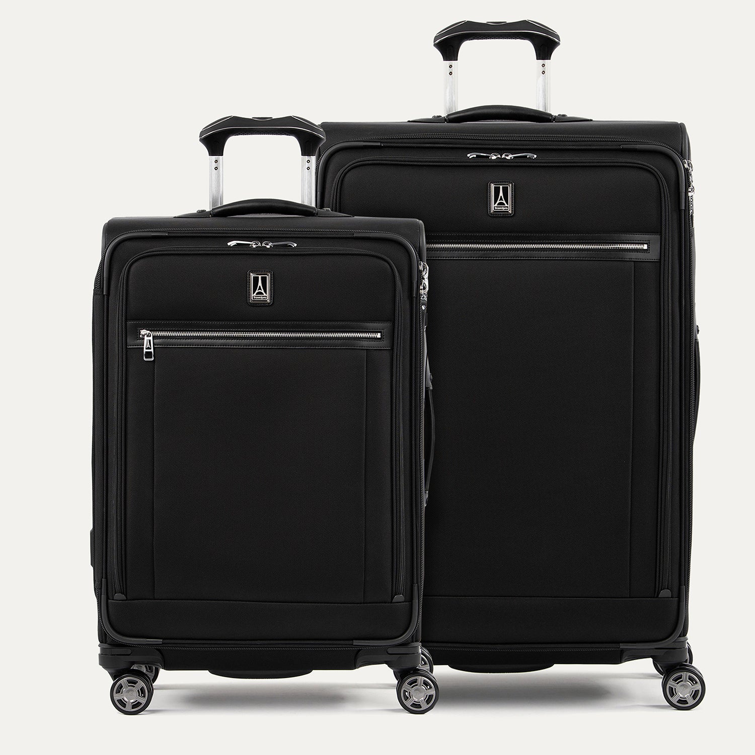 A set of two black suitcases with spinner wheels, both with the Travelpro logo on the front on a white background