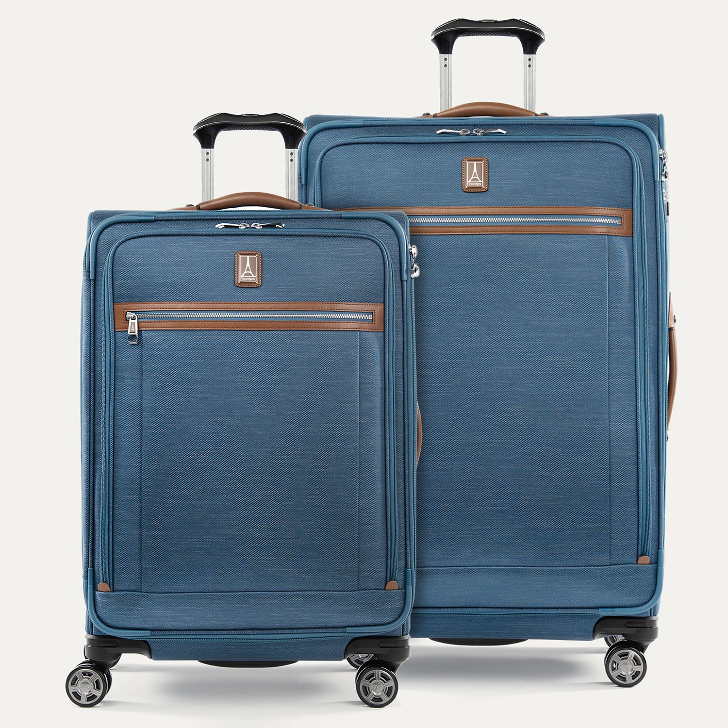A set of two blue suitcases with spinner wheels and brown accents on a white background