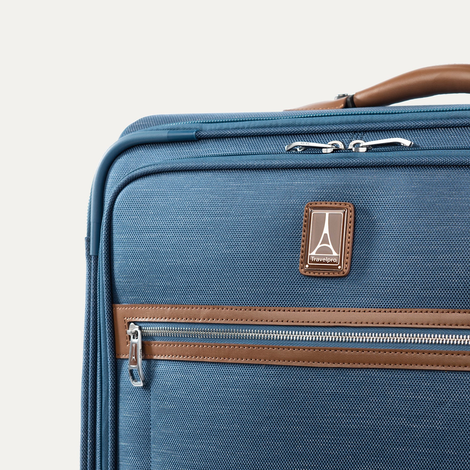 Blue suitcase with brown accents on a plain background