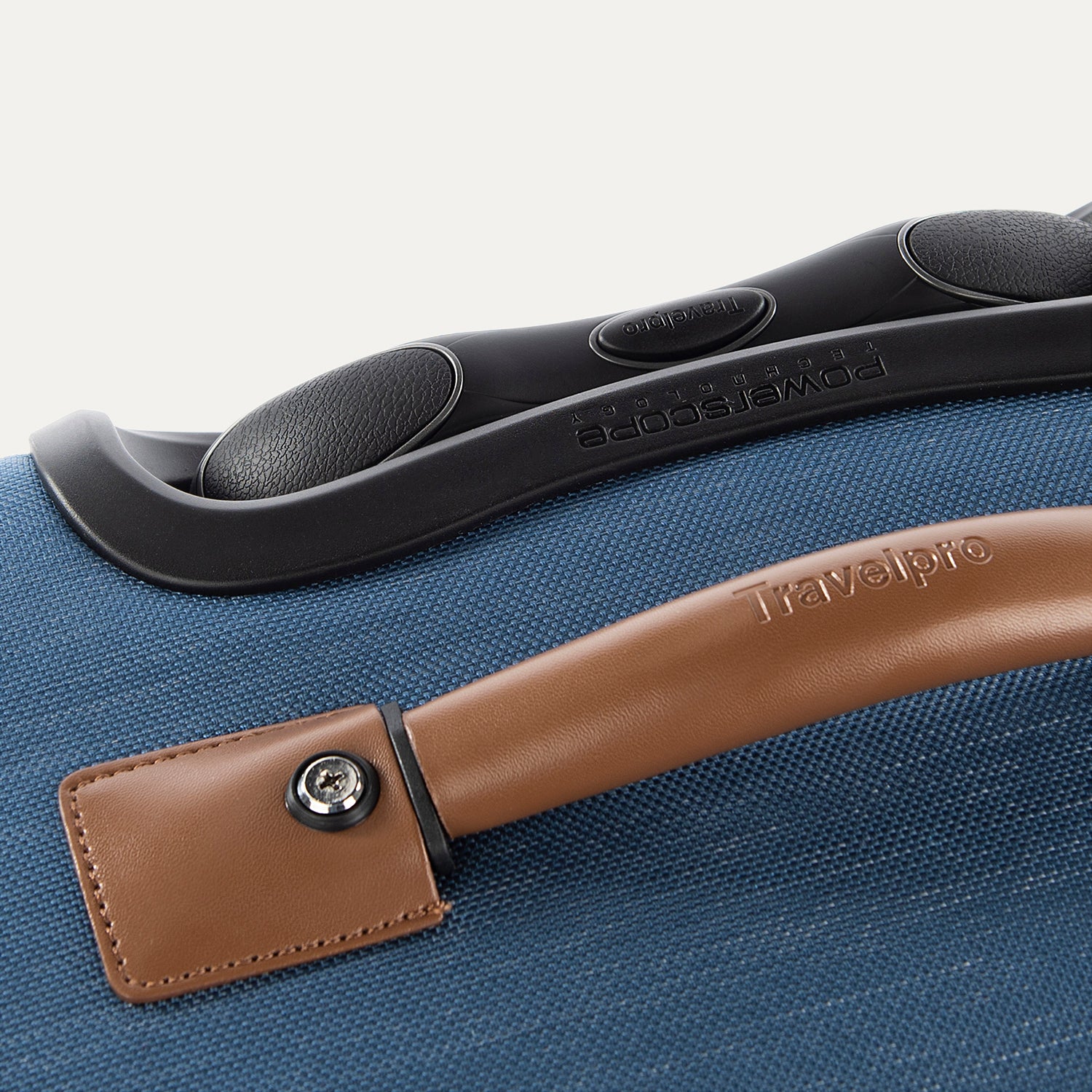 Close-up of a blue suitcase handle and grip.