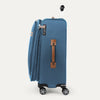 Blue suitcase with brown handle on a white background