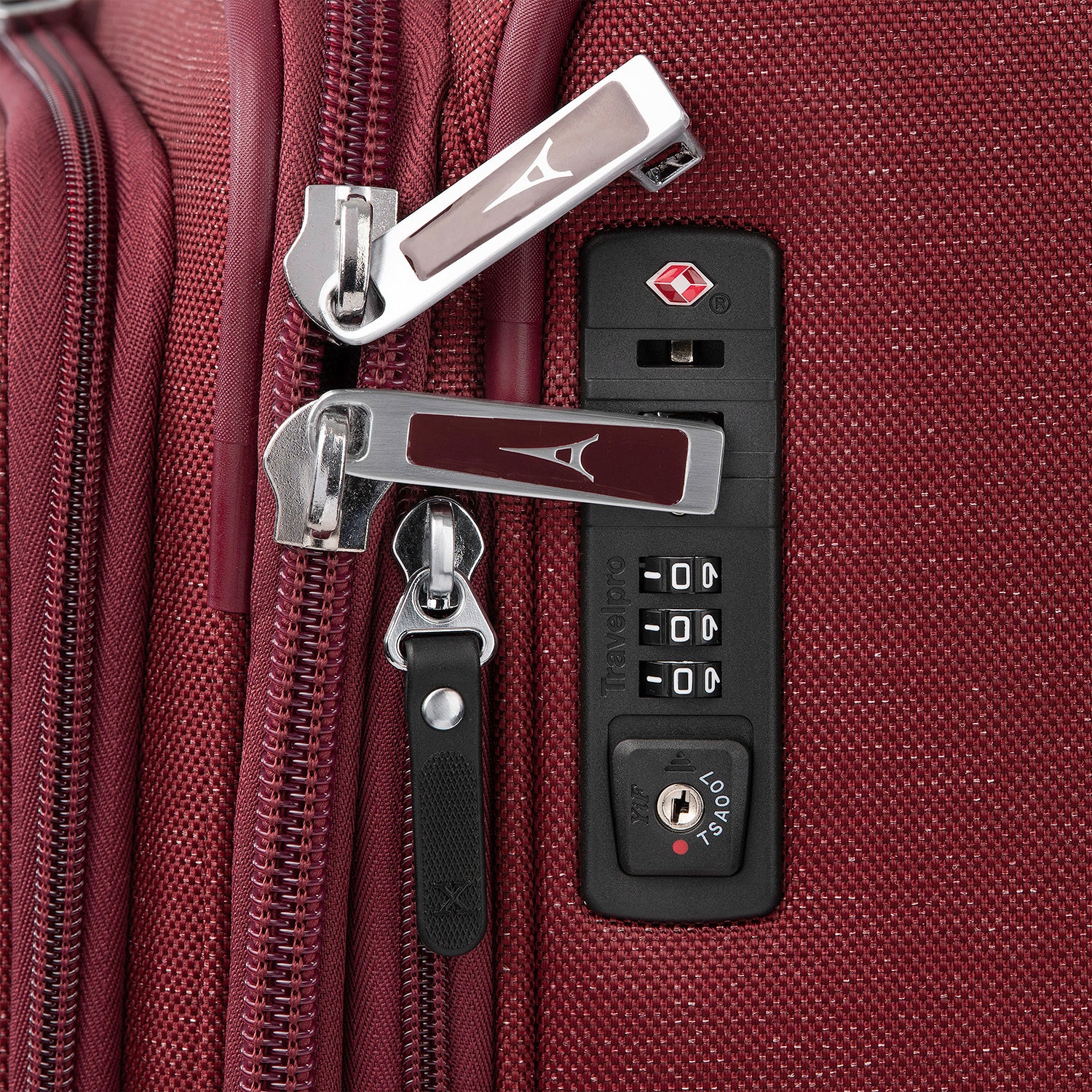 Close-up of a red suitcase with zipper and lock.