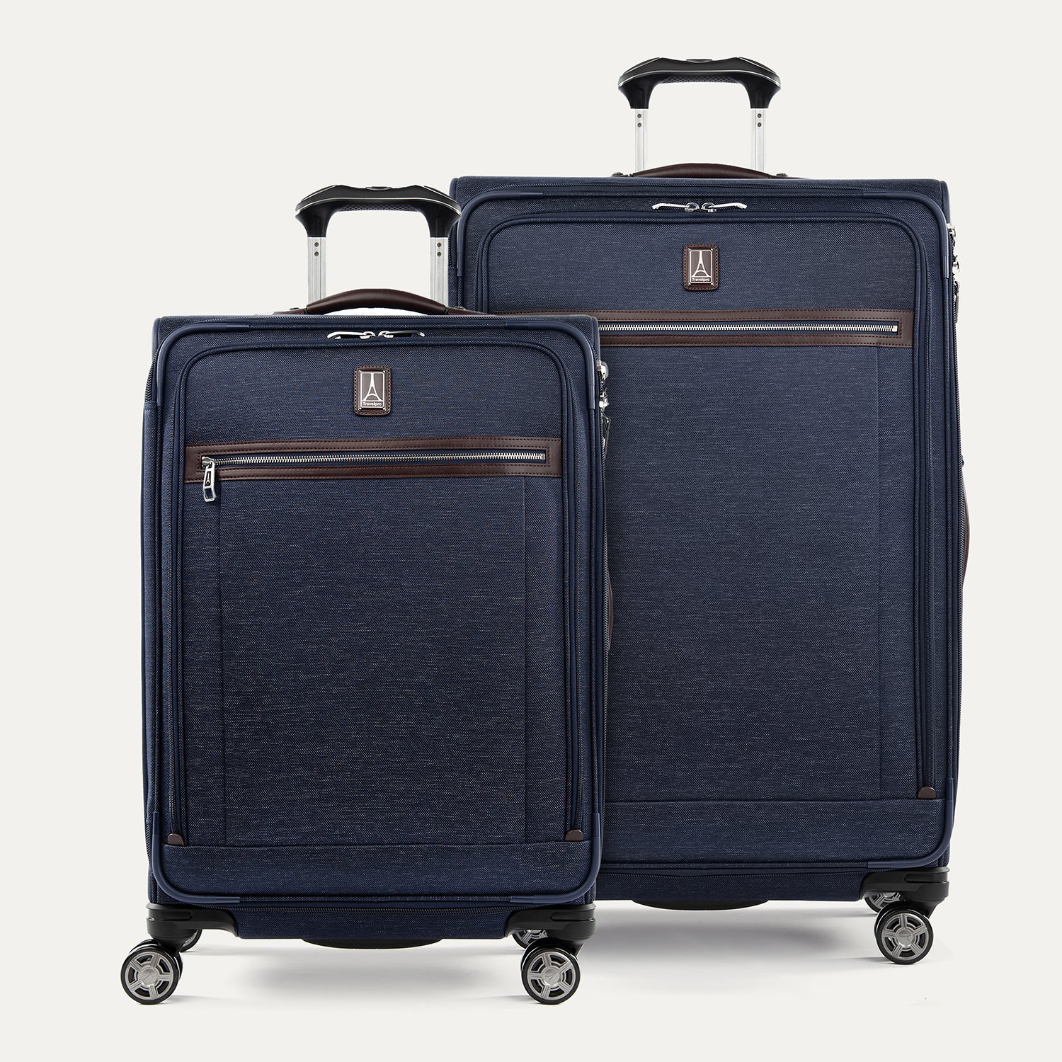 A set of two navy blue suitcases with spinner wheels , a power scope handle and branded with Travelpro logo.