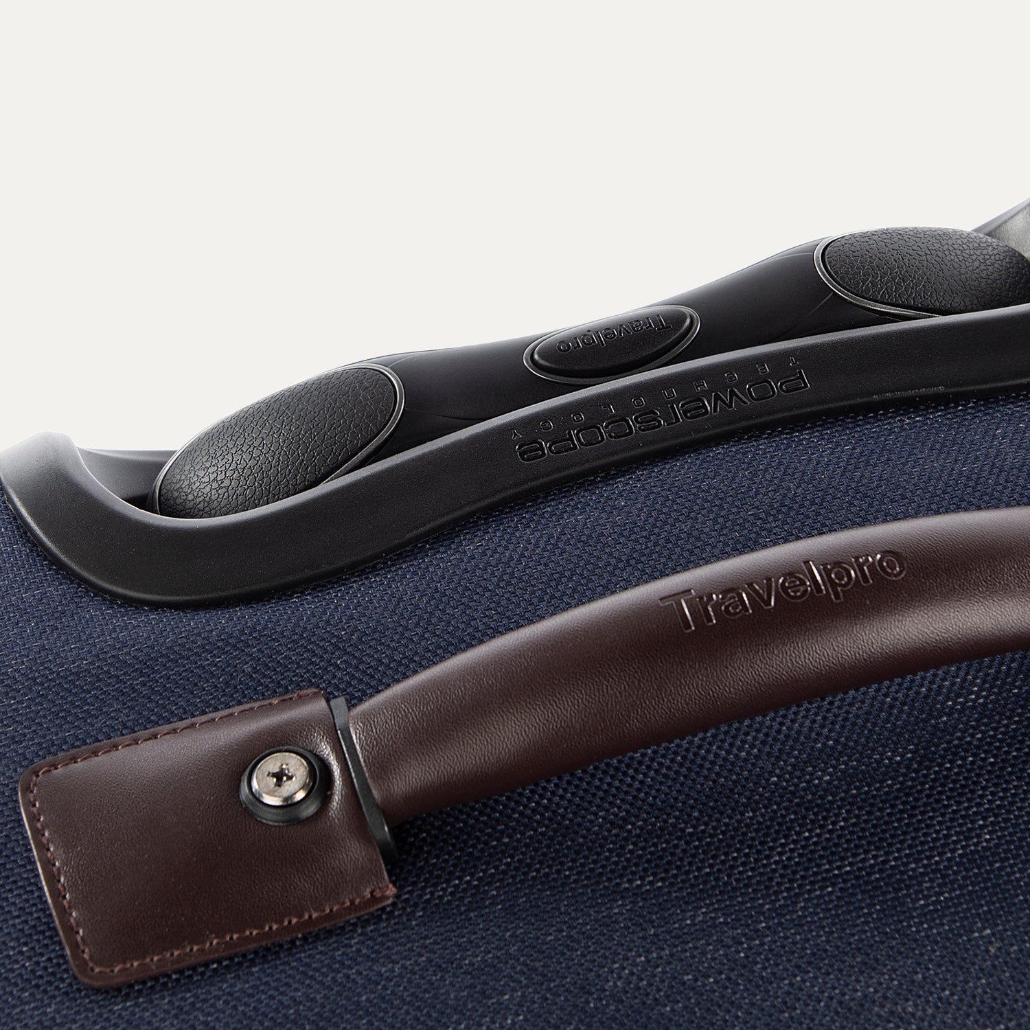 Close-up of a suitcase handle and grip on a blue suitcase.