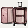 Black open suitcase with the interior compartments in pink interior with mesh pockets and a fold-out suiter