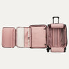 Pink suitcase with suiter compartment open on a white background