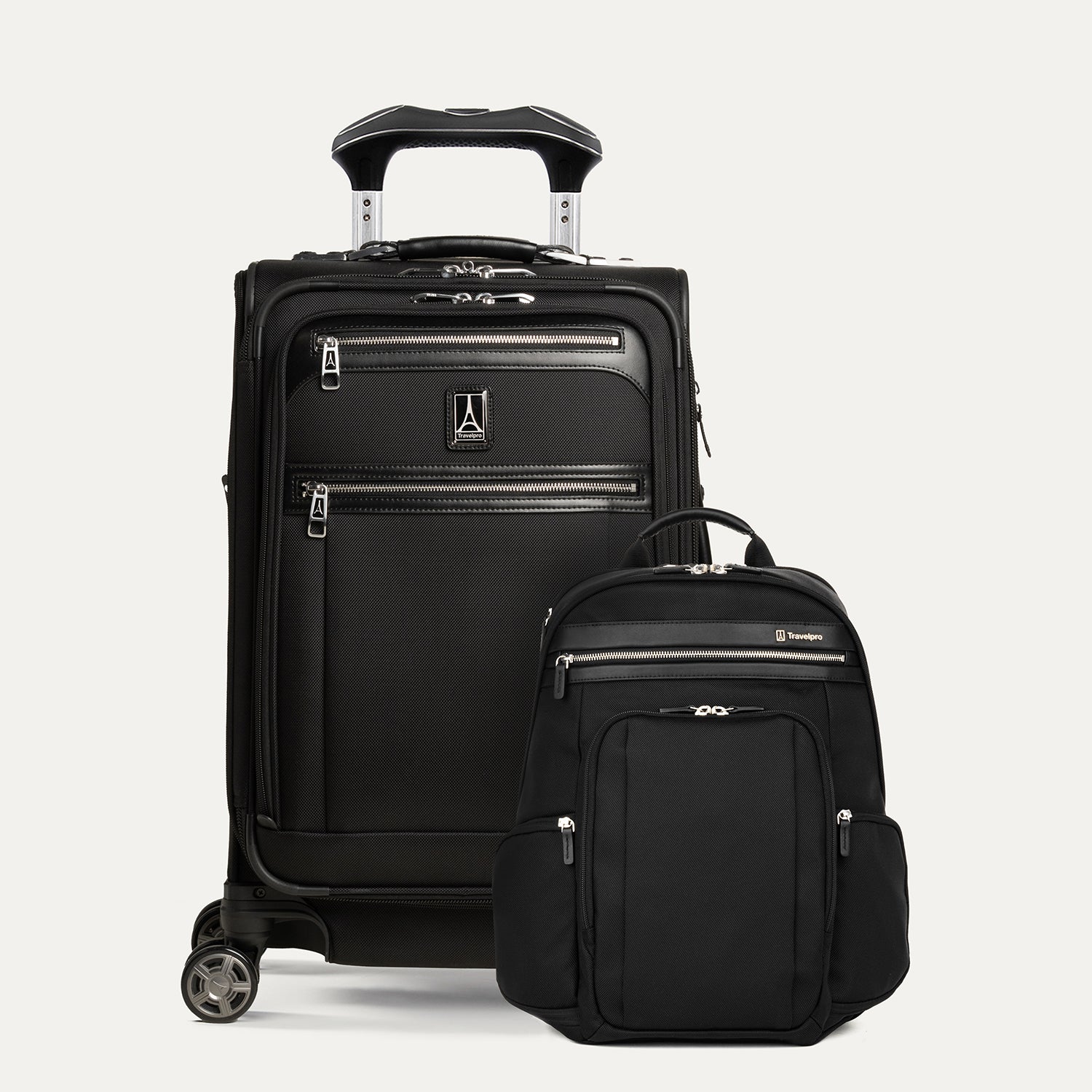 A set of travel luggage consisting of a carry-on spinner suitcase and a business backpack, both in black color with premium fabrics and leather accents.