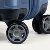 Close-up of a blue suitcase with black wheels on a white background