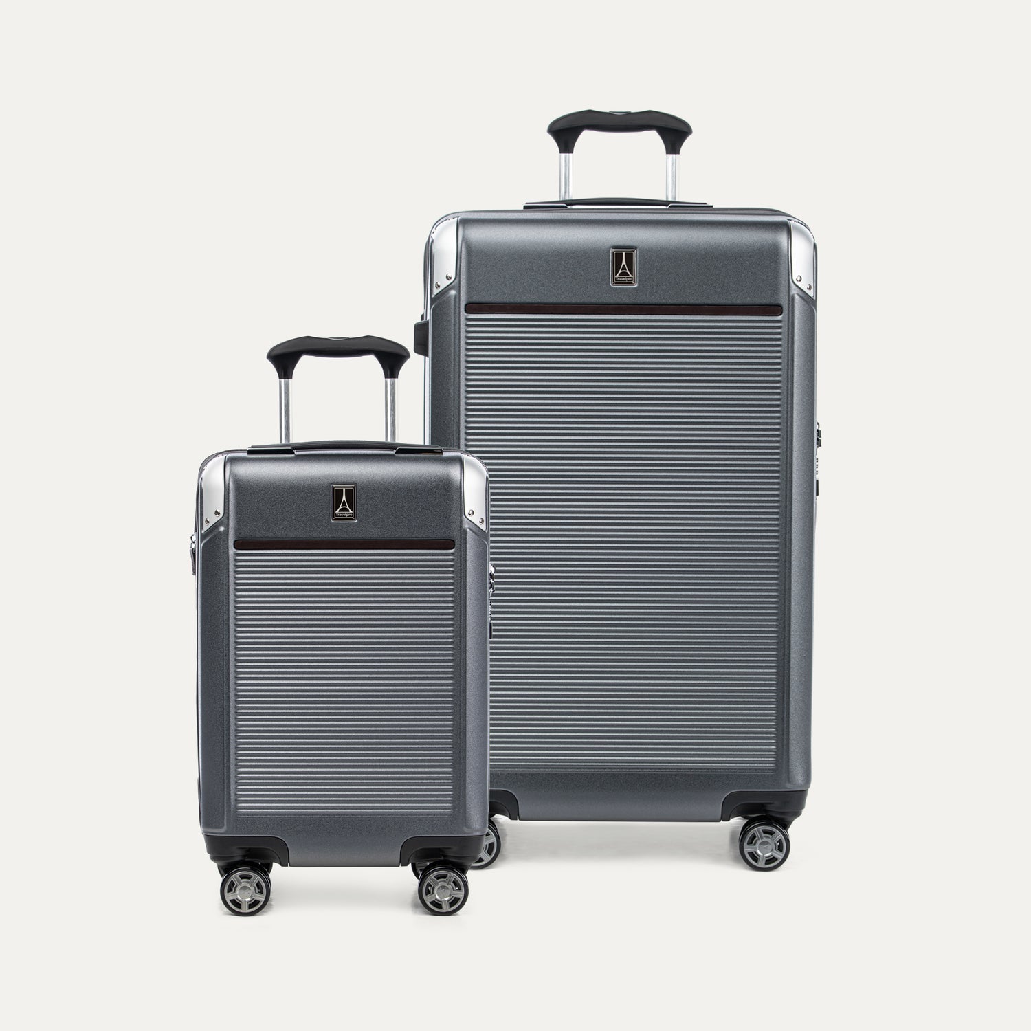 Two gray suitcases with a visible travelpro logo on a white background