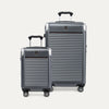 Two gray suitcases with a visible travelpro logo on a white background