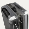 Gray suitcase with USB port and charging cable on a white background