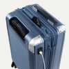 Top view of Travelpro Platinum Elite Hardside Spinner in Dark Sky Blue, showing USB Charging Port and built-in battery pouch.