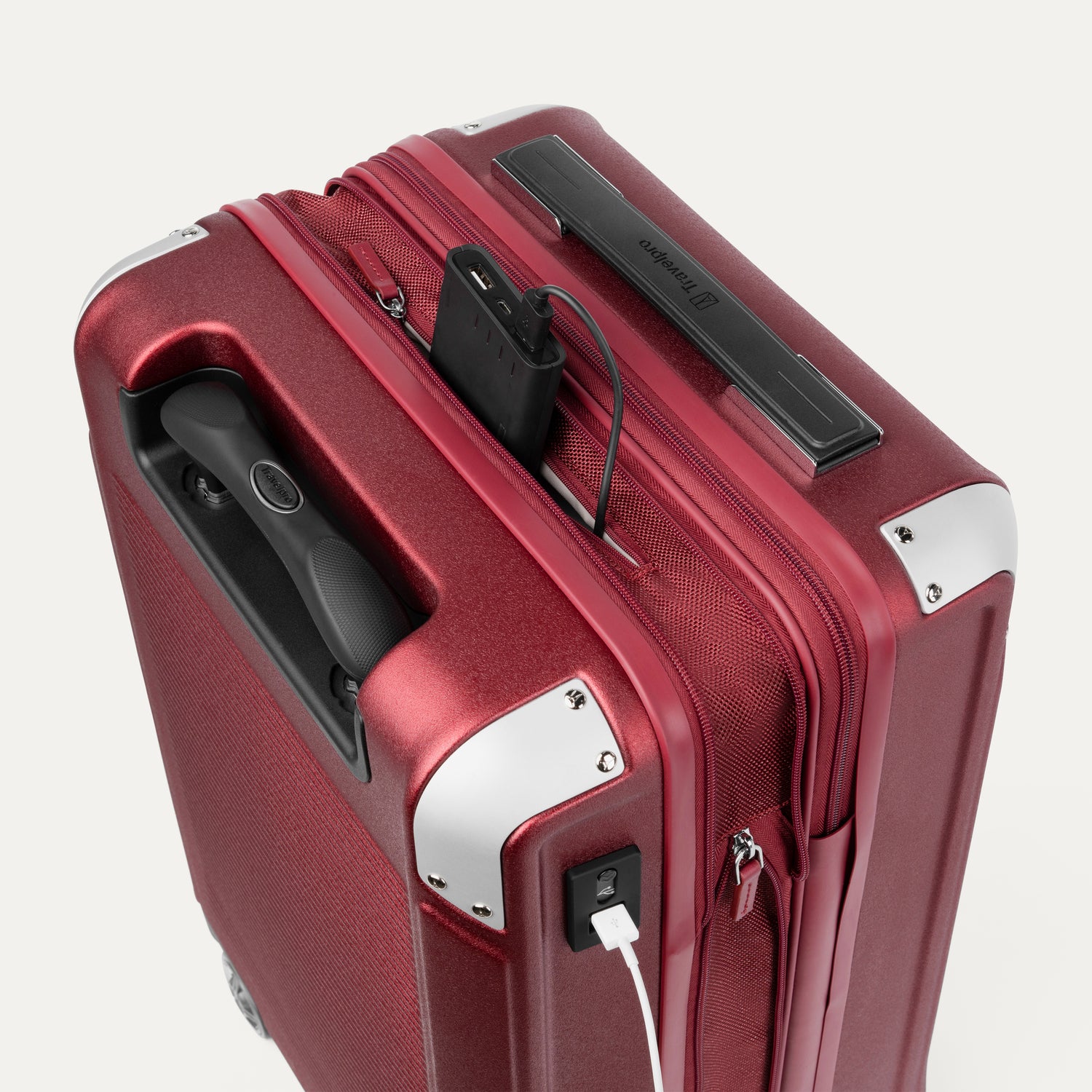 Top view of Travelpro Platinum Elite Hardside Spinner in Daring Red, showing USB Charging Port and built-in battery pocket