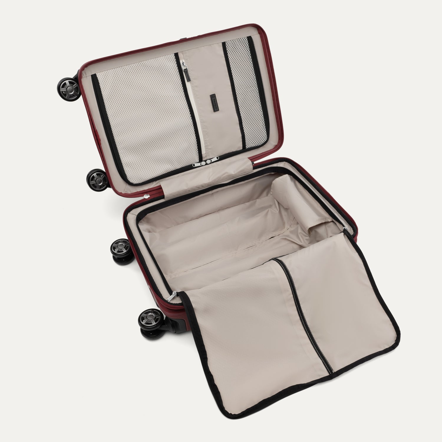 Interior view of Travelpro Platinum Elite Hardside Spinner in Daring Red, featuring zippered divider panel and mesh organizational pockets.