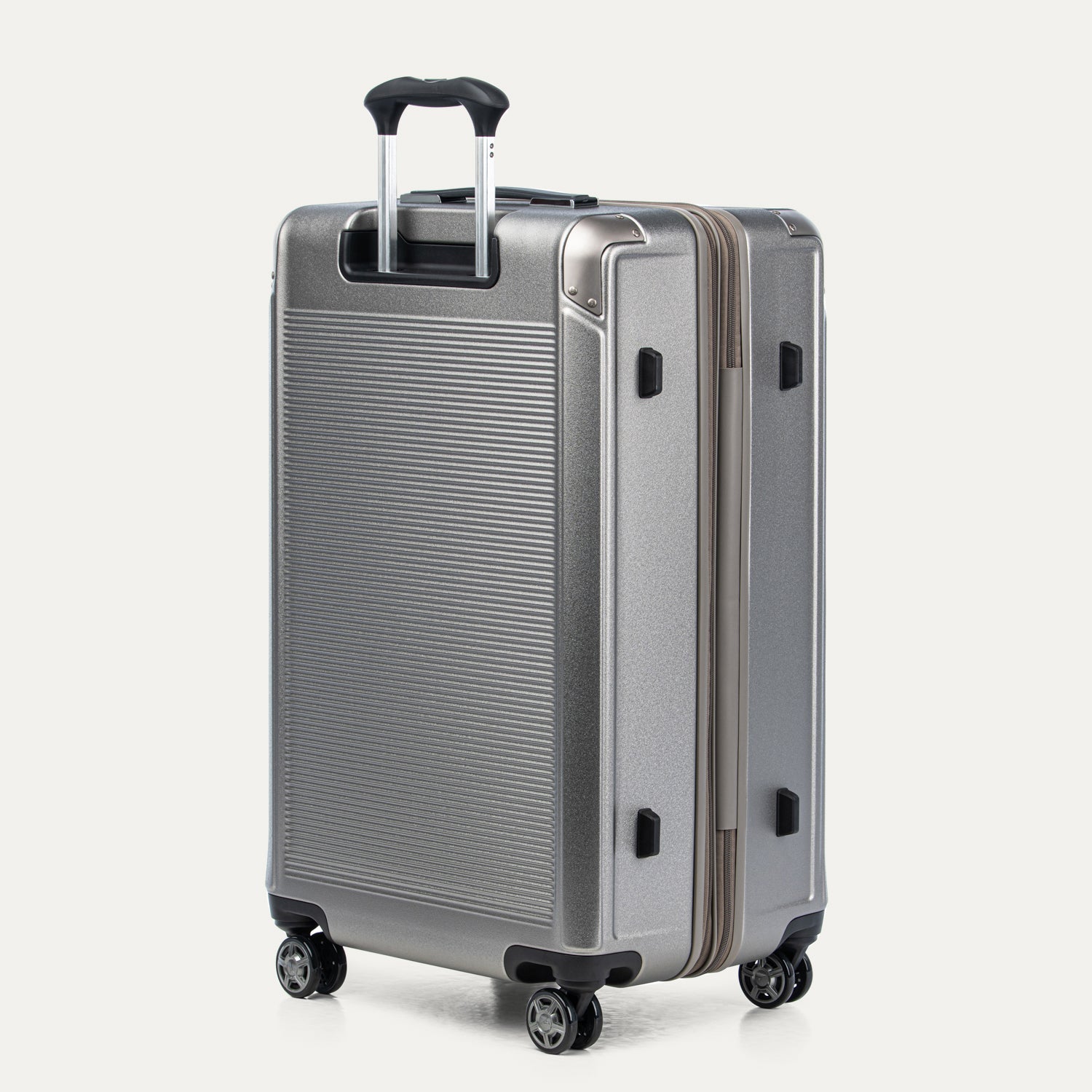 Metallic sand suitcase with a textured surface on a white background