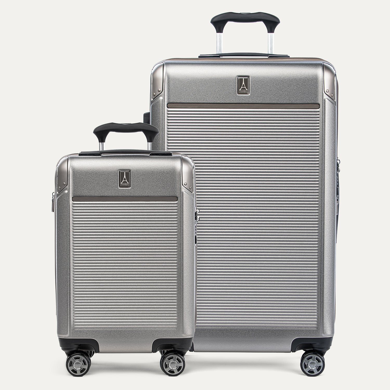 A set of two Platinum Elite hardside spinner suitcases, one carry-on and one check-in size, in metallic sand color with aluminum corner armor and a textured finish.