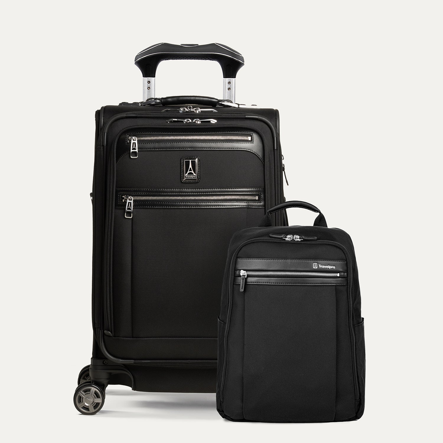 A set of black travel luggage, featuring a carry-on spinner suitcase and a slim backpack, both with the travelpro brand logo.